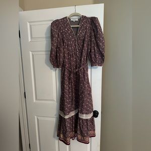 Hunter Bell Bowen Dress in Falling Leaves Print. Background is a grayish purple.